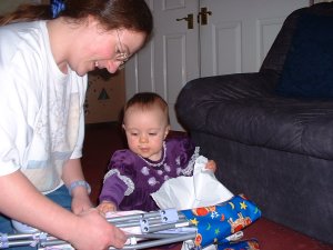 Mummy helps Jenny unwrap her presents